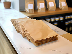 An image of paper merchandise bags sitting on a counter