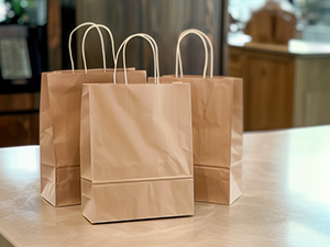 An image of kraft paper bags sitting on a table in a store